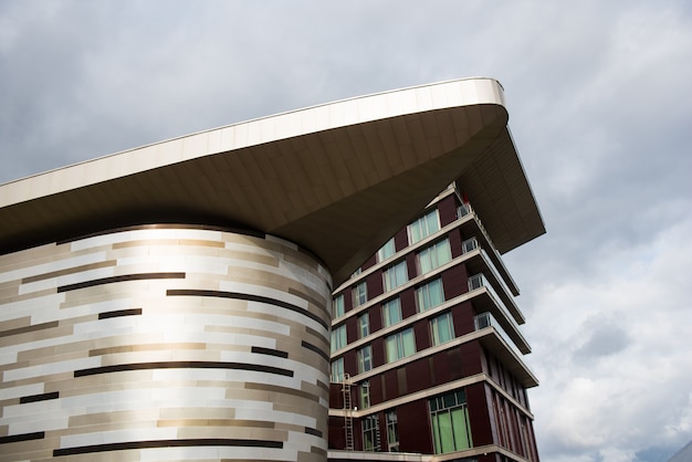 detail view of the top of a modern building. angular form design. pattern with glass windows and lines. architecture with sharp angle.