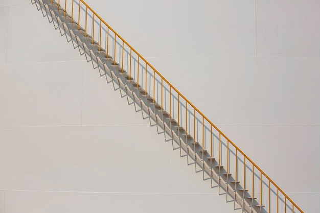 Detail of white tanks in tank farm with iron staircase