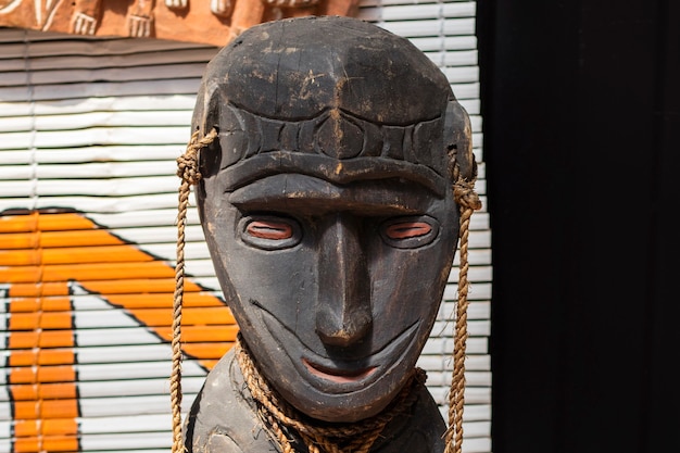 Detail of a woman figure made of wood. head with a smile on his face. close-up