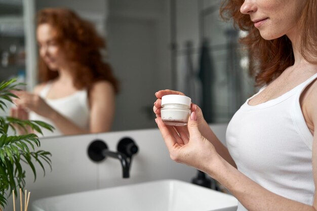 Detail of woman holding face cream