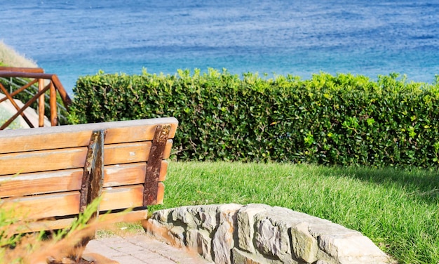 Detail of a wooden bench by the sea