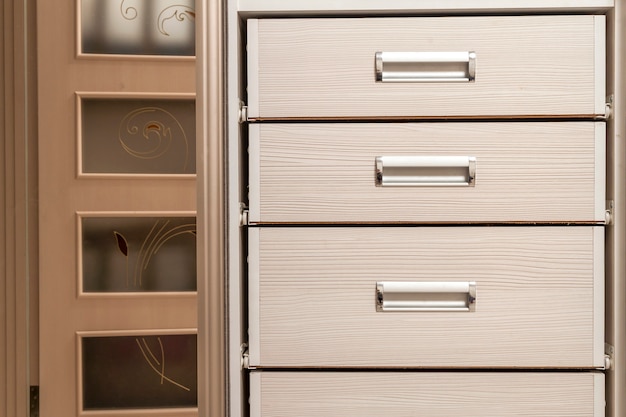 Photo detail of wooden furniture cabinet chest with drawers front, metal handles, vintage style