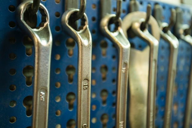 Photo detail of wrenches and tools hanging in the workshop