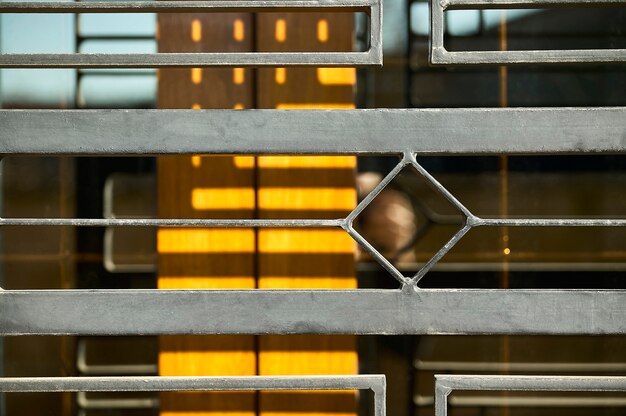 Detail of wrought iron door used to protect a house typical of the 70s in Italy.