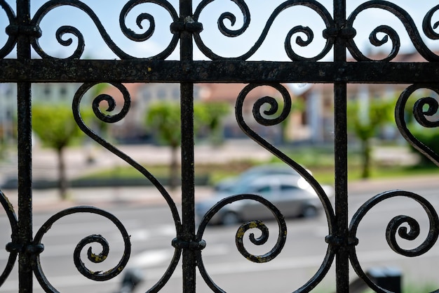 Photo detail of a wrought iron fence on a street in the city selective focus