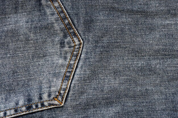 Детальная абстрактная текстура темно-синей джинсовой ткани Фоновое изображение старой использованной джинсовой ткани брюк