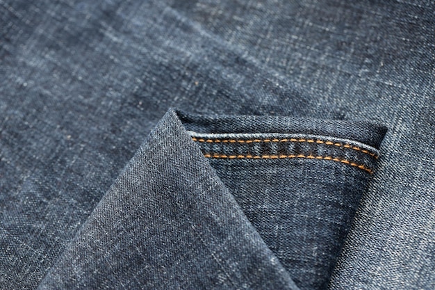 Детальная абстрактная текстура темно-синей джинсовой ткани фоновое изображение старой использованной джинсовой ткани брюк