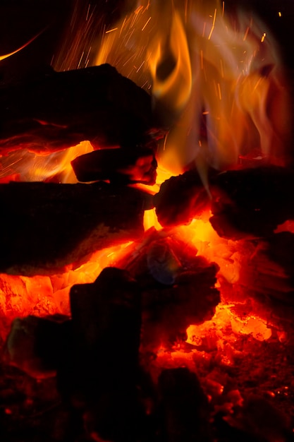 Detailed closeup of wooden planks burning in a bonfire