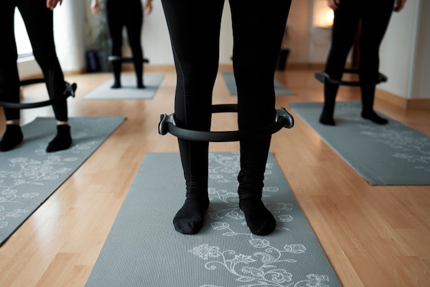 Detailed drawing of women using the Pilates leg ring