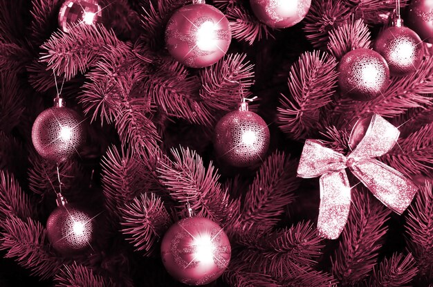 Detailed photo of the christmas tree image toned in viva magenta color of the  year