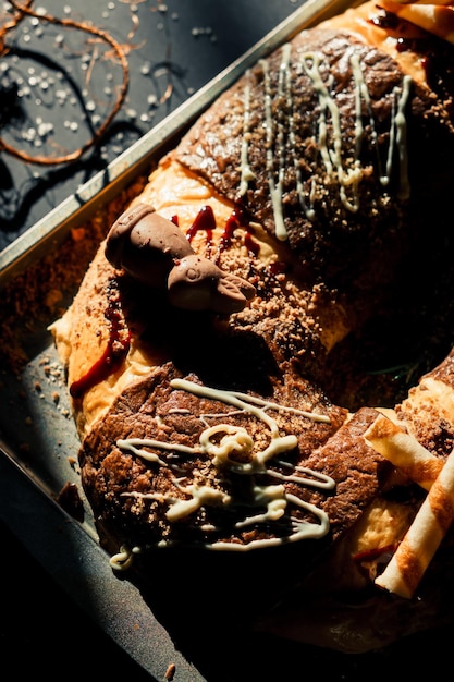 Detailed plan of a chocolate rosca de reyes. Black background.