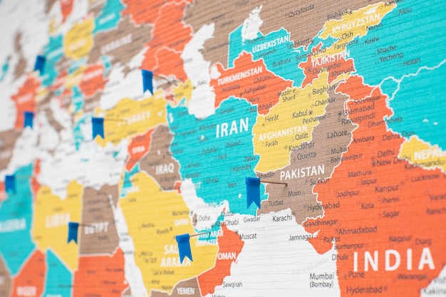 Photo detailed political map fragment of asia with the flag pins set on different countries