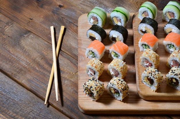 A detailed shot of a set of Japanese sushi rolls and a device for their use chopsticks