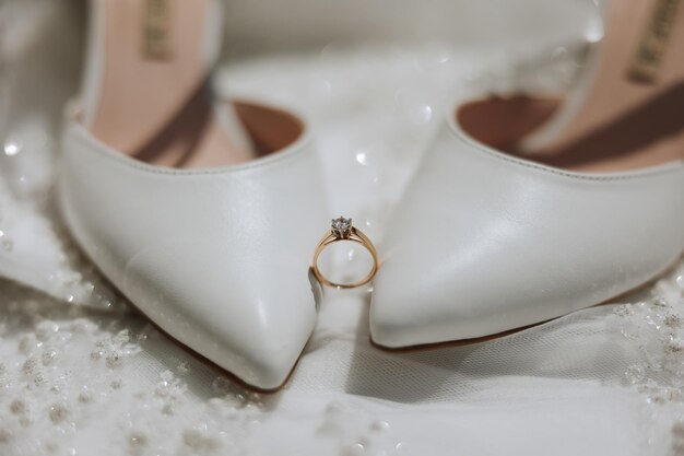 Photo details of the bride beauty is in the details highheeled bridal shoes gold wedding ring with a diamond perfumes earrings wedding in details