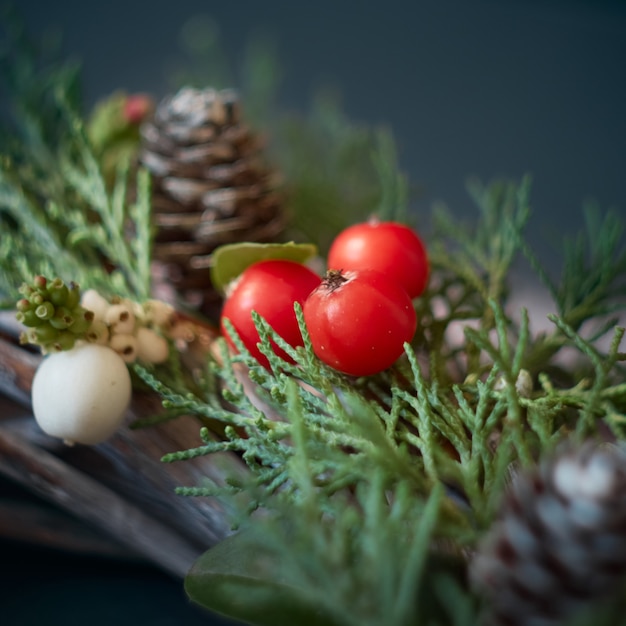 Details of Christmas wreath of fresh spruce, cones and ÃÂhristmas decorations, close up. New Year decorations.