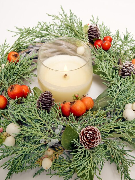 Photo details of christmas wreath of fresh spruce, cones and ãâhristmas decorations, close up. new year decorations.