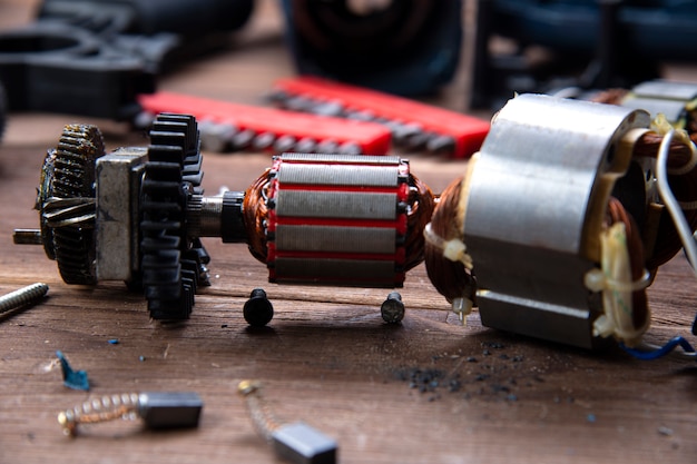 Details of electrical appliance and repair tools on a wooden table in a repair shop