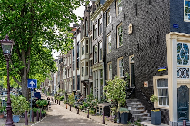 Details and facades of Amsterdam characteristic brick construction of residential building in Amsterdam School style High quality photo