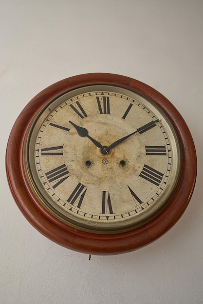 Details of an old clock on white wall