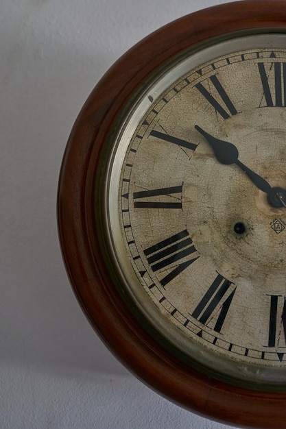 Details of an old clock on white wall