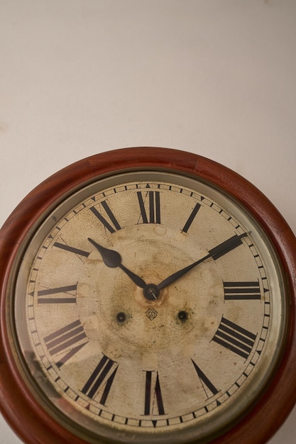 Details of an old clock on white wall