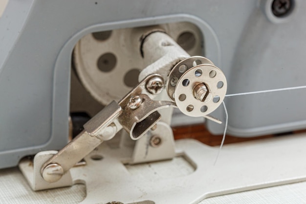 Details of a sewing machine spool of thread