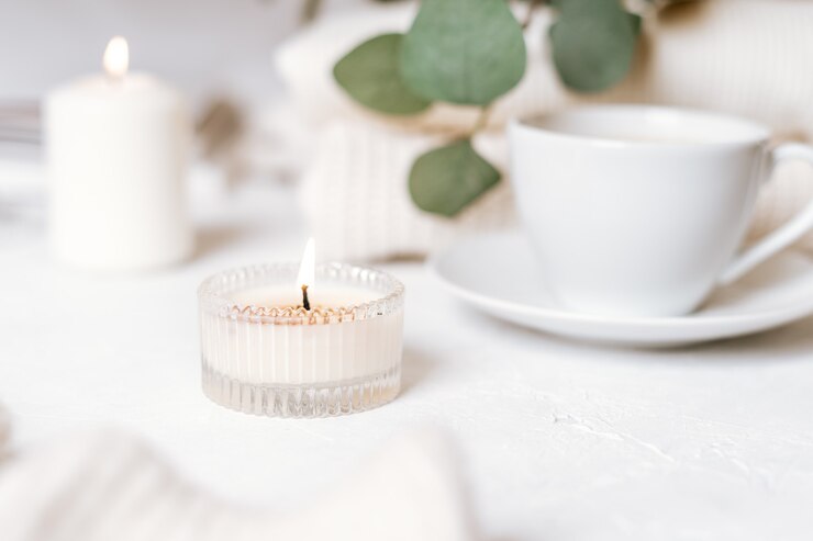 Details of still life in the home interior of living room. Cup of coffee, cotton, book, candle, sweater. Moody. Cosy autumn winter concept on white . Decoration.