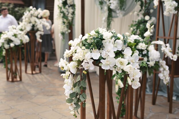 Details Wedding ceremony in the open air of fresh flowers with candles