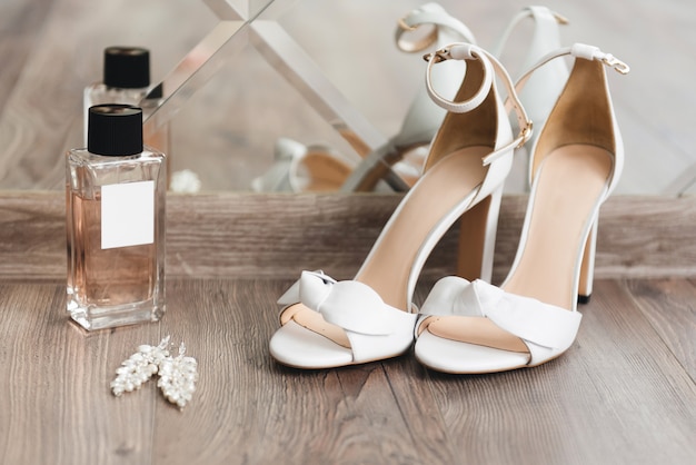 details of the wedding day. Bride's shoes on a light background top view