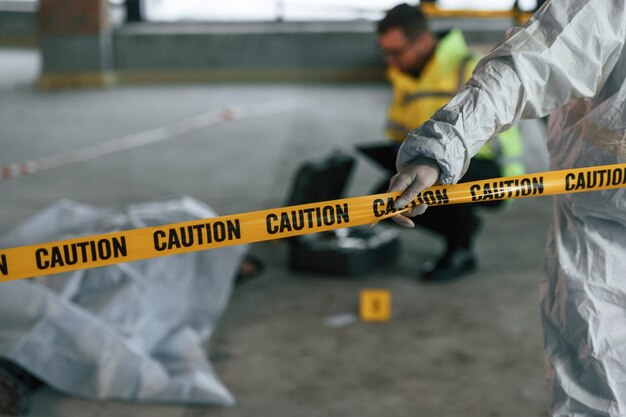 Photo detectives are collecting evidence in a crime scene near dead body