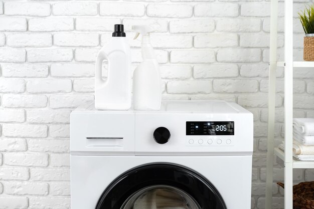 Photo detergent bottle on washing machine in a laundry room