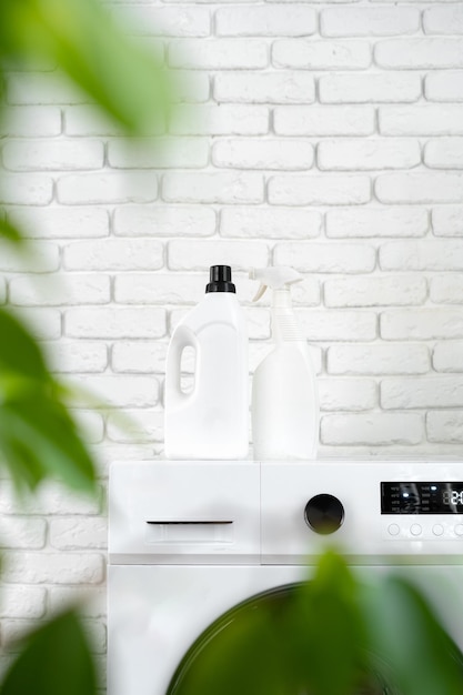 Detergent bottle on washing machine in a laundry room