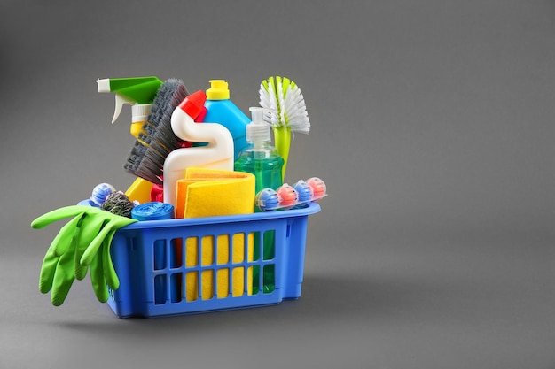 Detergent bottles and cleaning supplies in a bucket