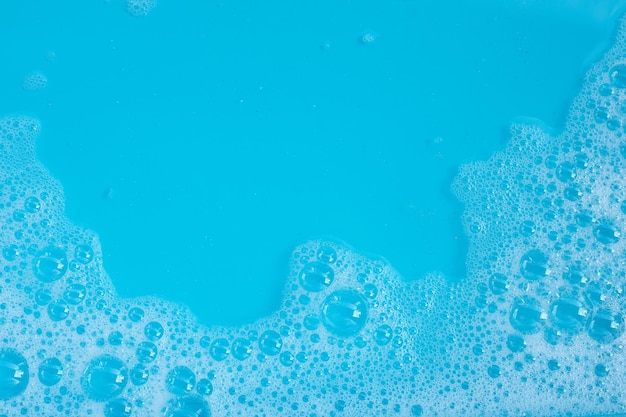 Photo detergent foam bubble on blue background