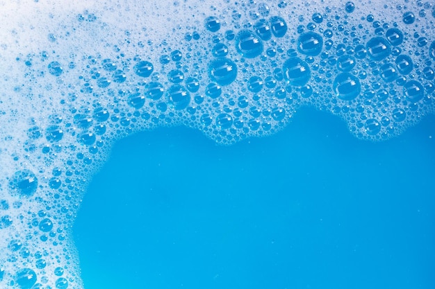 Photo detergent foam bubble on blue background