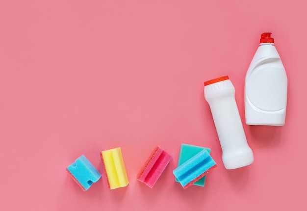 Detergents and sponges isolated on pink