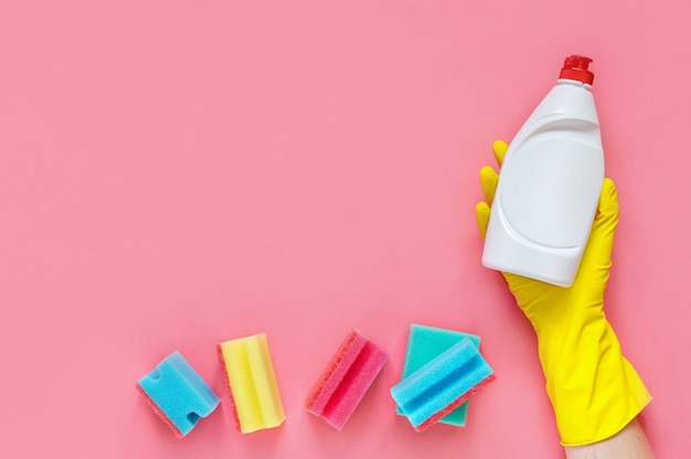 Detergents and sponges isolated on pink