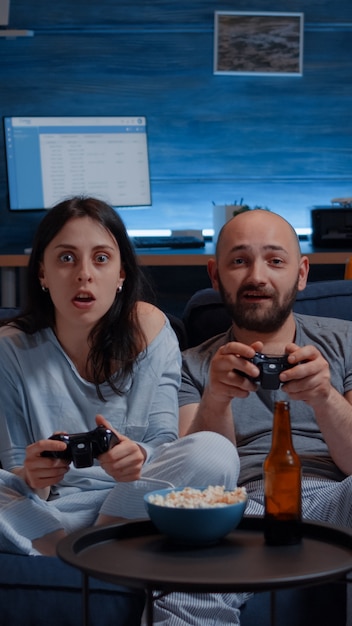 Determinated excited couple winning video games