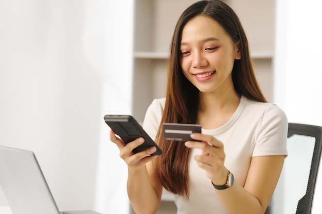 determined asian chinese people housewife using calculator and credit cards to keep track of her family's expenses and budget housewife managing household expenses and credit cards