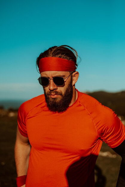 A determined athlete preparing for the start of training on the top of the mountain at sunrise.