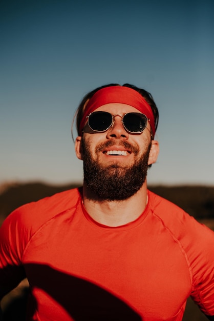 A determined athlete preparing for the start of training on the top of the mountain at sunrise.