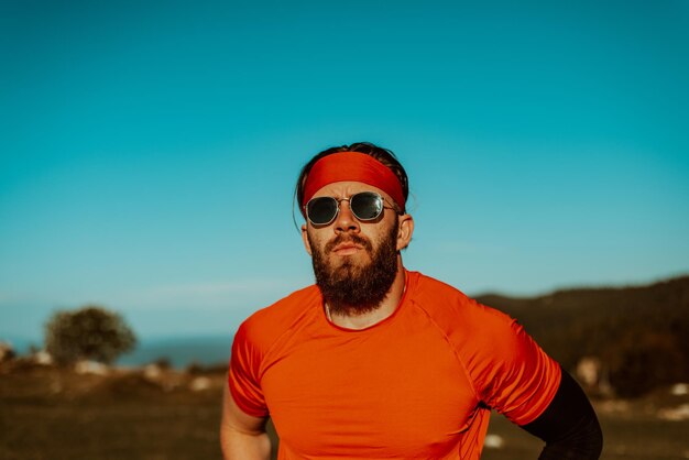 A determined athlete preparing for the start of training on the top of the mountain at sunrise