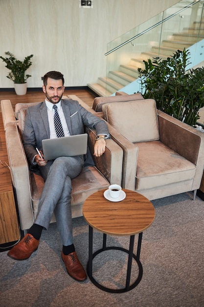 Determined business professional with a laptop at the coffee table