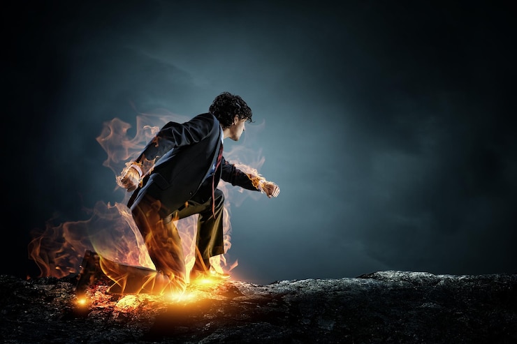 Photo determined businessman leaving fire trails on asphalt. mixed media