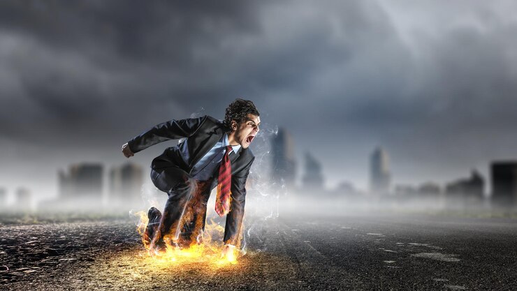 Photo determined businessman leaving fire trails on asphalt. mixed media
