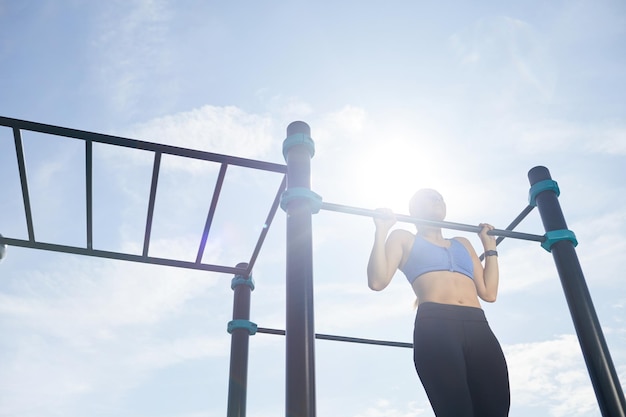 Determined girl doing pullup