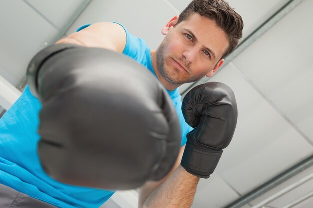 Determined male boxer focused on training