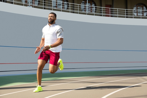 Determined serious african american young sportsman jogging outdoors