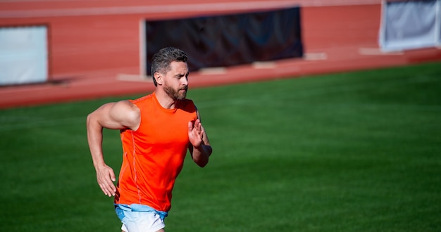 Determined to win sport athlete run fast to win successful\
fitness sprinter coach on stadium