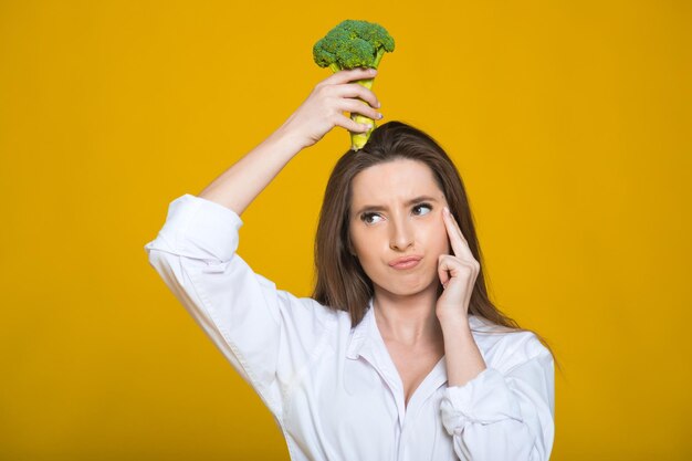 Detox diet concept Woman holds green broccoli sprouts for healthy nutrition